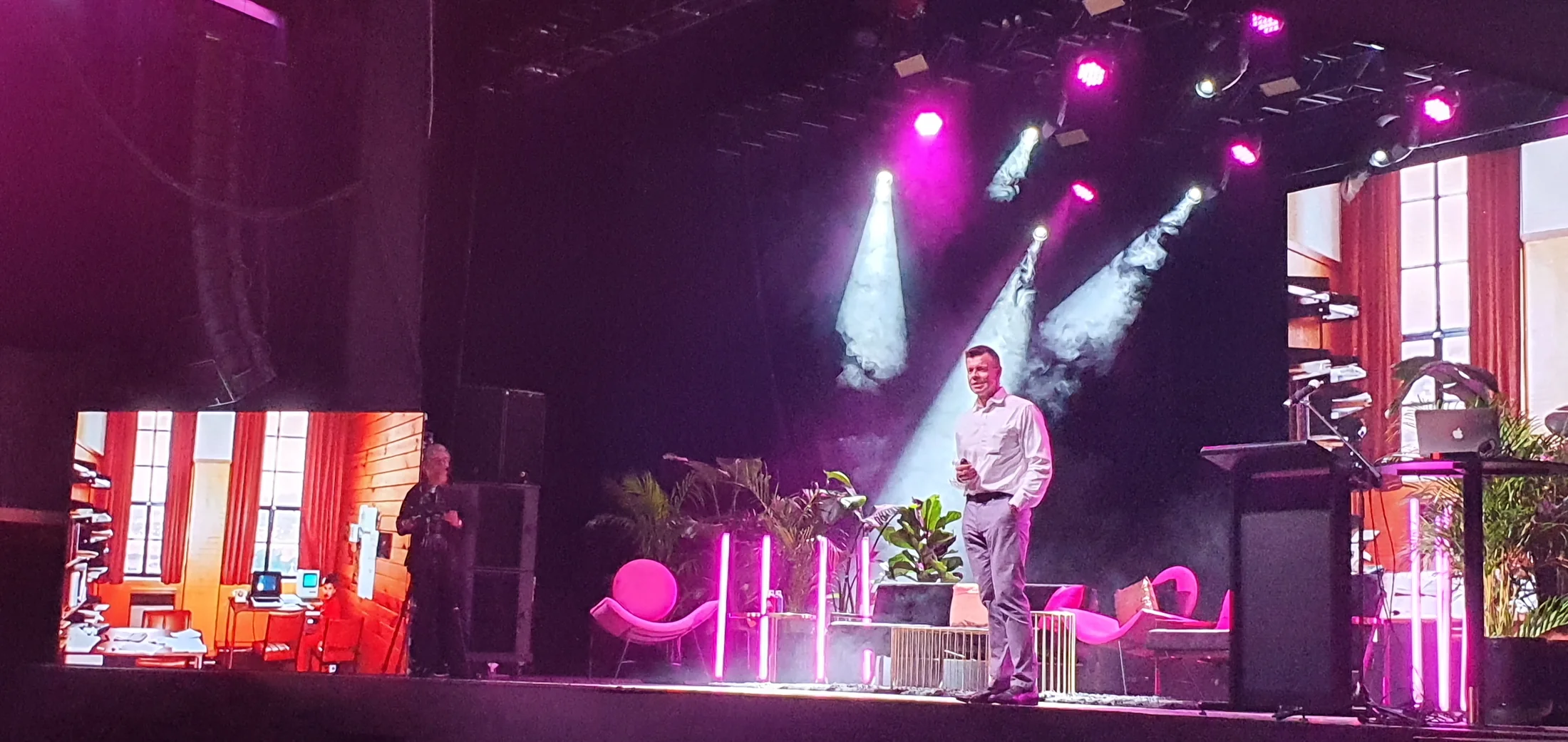 Matthew speaking under stage lights